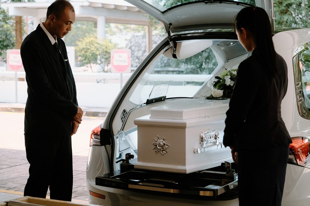 Harris 'Abang' assisting a funeral with a co-worker